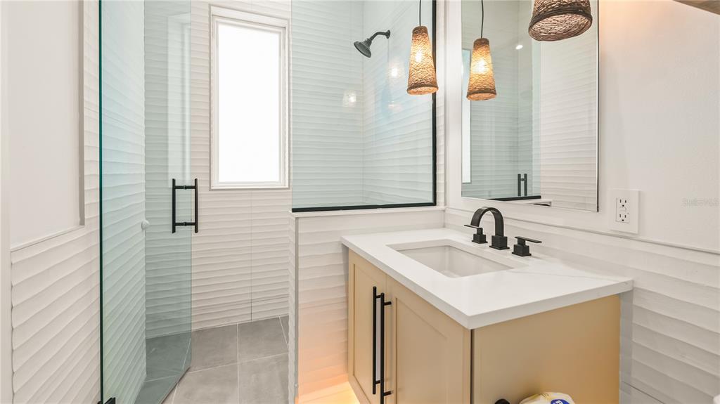 6536 Peacock Road Sarasota, FL 34242 - Photo 62 of 82 a bathroom with a sink and a mirror