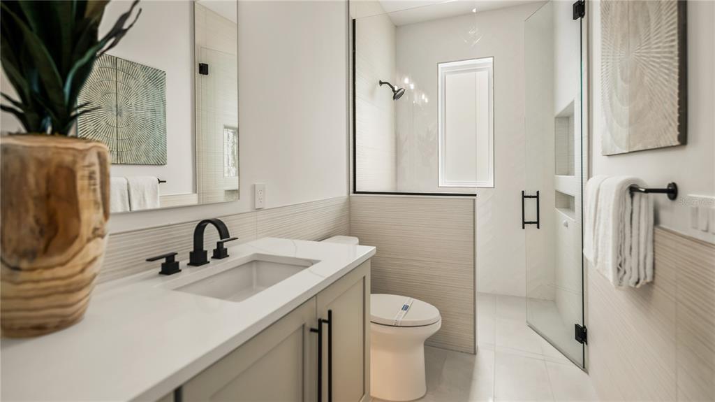 6536 Peacock Road Sarasota, FL 34242 - Photo 63 of 82 a bathroom with a sink a toilet and shower