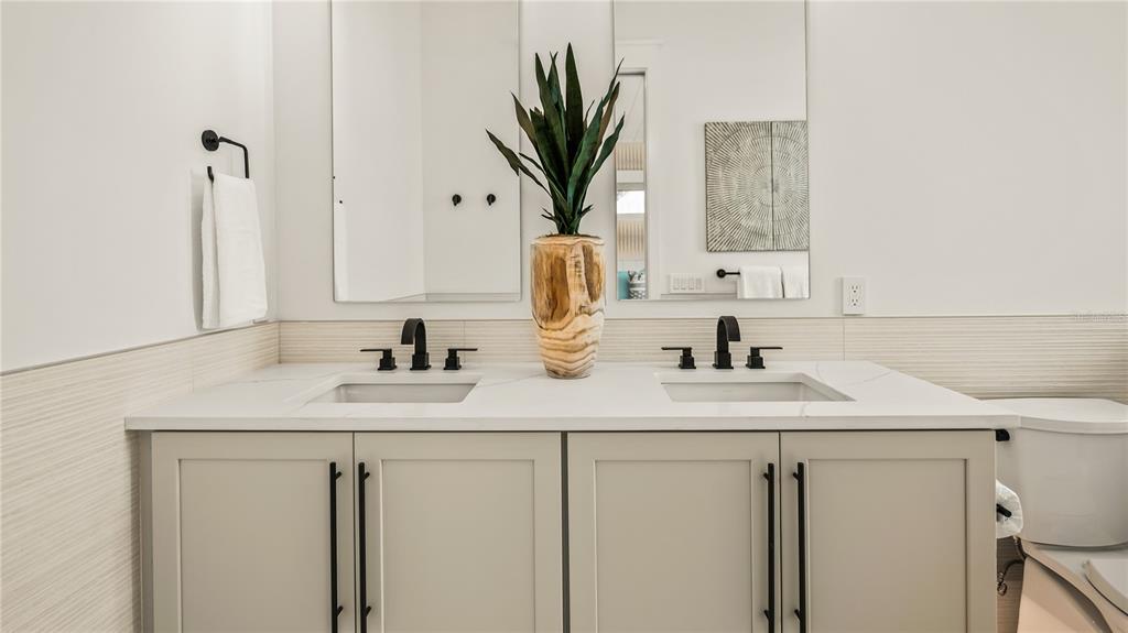 6536 Peacock Road Sarasota, FL 34242 - Photo 66 of 82 a bathroom with a sink a vanity and a mirror