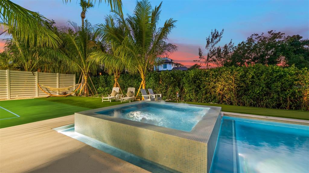 6536 Peacock Road Sarasota, FL 34242 - Photo 70 of 82 a view of a swimming pool with a yard and palm trees