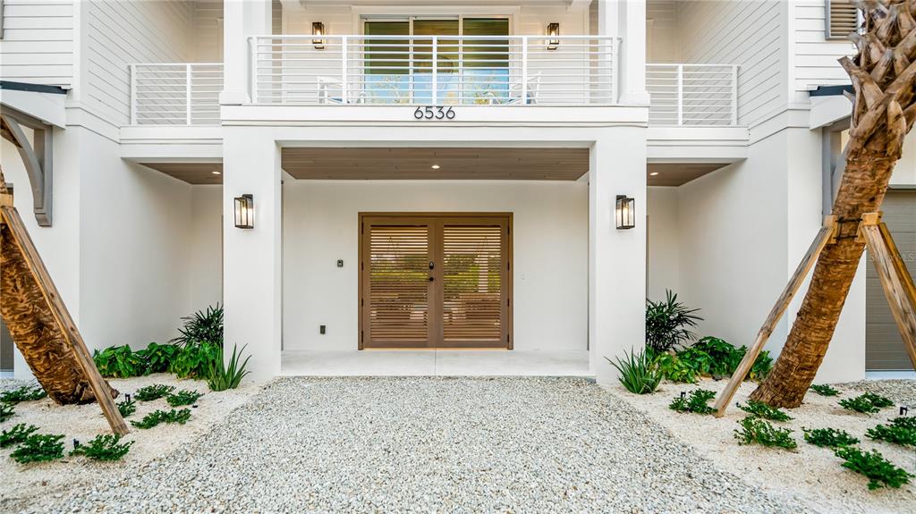 6536 Peacock Road Sarasota, FL 34242 - Photo 8 of 82 a front view of a house with a yard