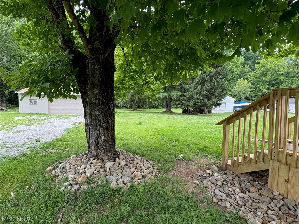 1448 Winding Road Parkersburg, WV 26104 - Photo 12 of 12 Expansive green space featuring mature trees and a gravel driveway