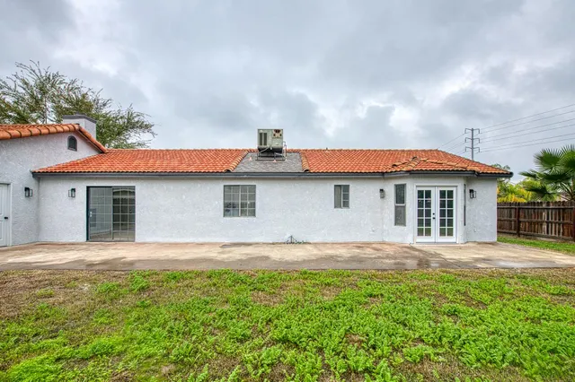 a front view of house with yard and trees around