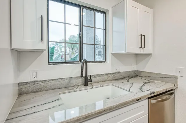 a sink sitting next to a window