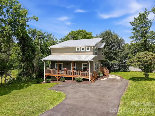a view of a house with garden and trees