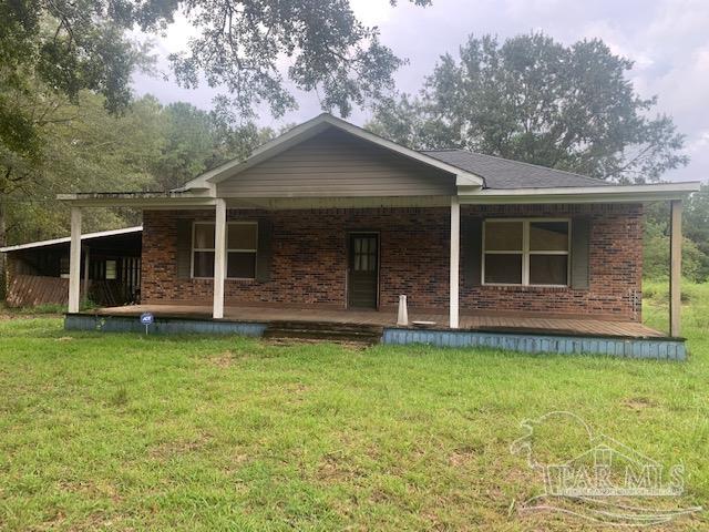 130 McKenzie Drive Atmore, AL 36502 - Photo 2 of 9 a front view of a house with a garden