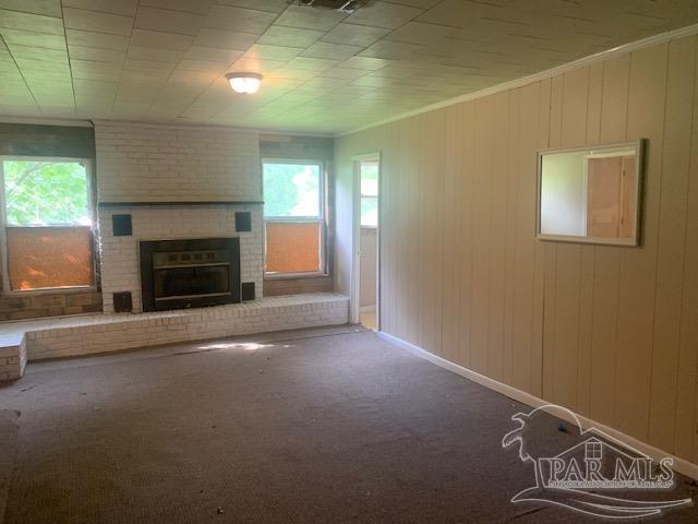 130 McKenzie Drive Atmore, AL 36502 - Photo 3 of 9 an empty room with a fireplace
