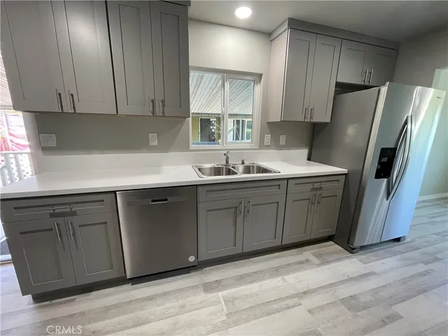 a kitchen with a sink appliances and cabinets