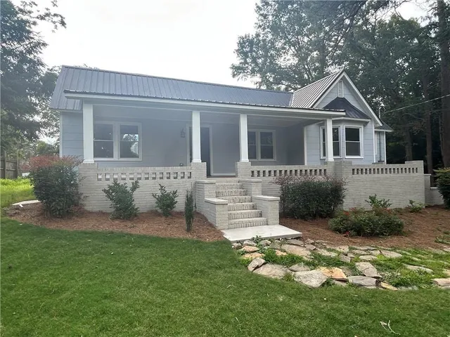 a front view of house with yard and green space
