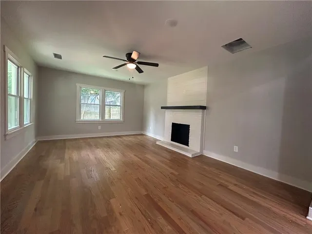 a large kitchen with stainless steel appliances granite countertop a stove and a sink