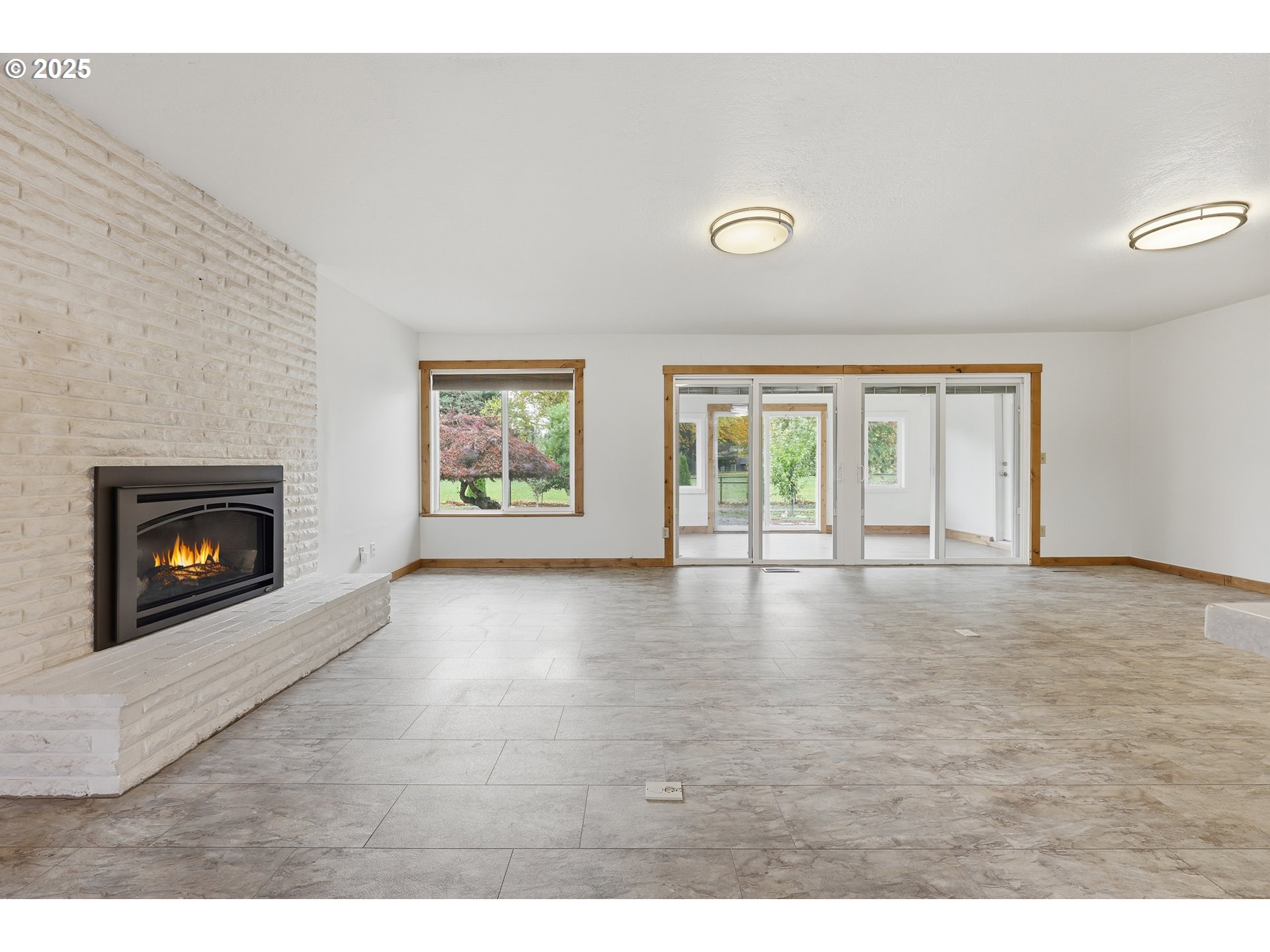 1920 Northeast View Court Gresham, OR 97030 - Photo 11 of 48 a view of an empty room with a fireplace and a window