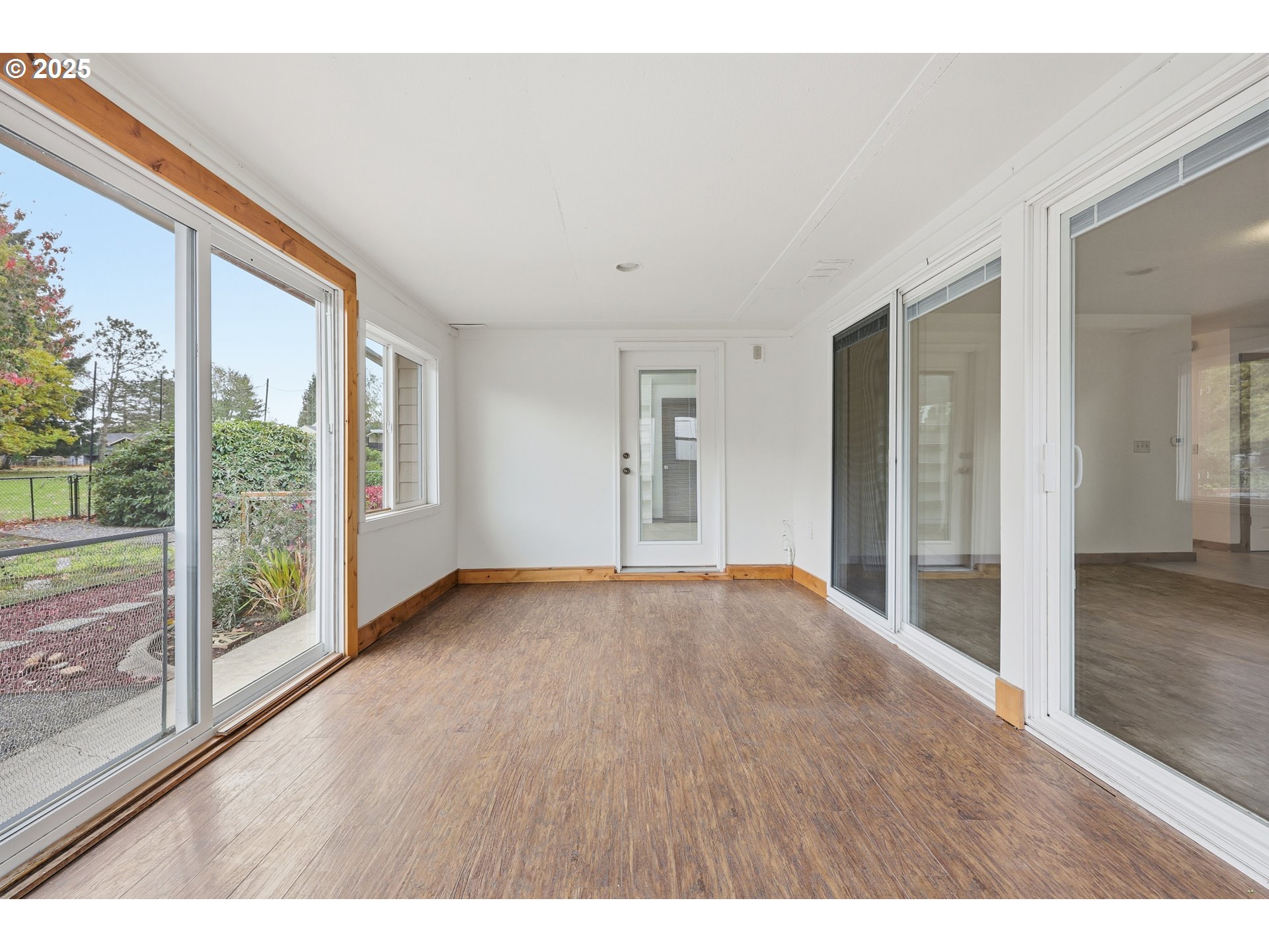 1920 Northeast View Court Gresham, OR 97030 - Photo 12 of 48 a view of an empty room with wooden floor and a window