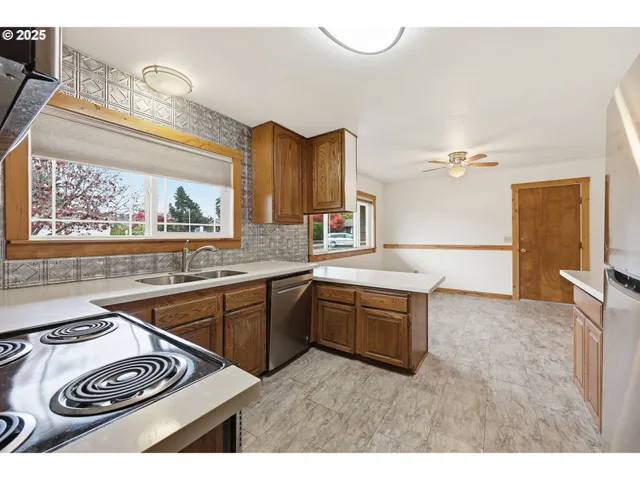 a kitchen with a stove a sink and a refrigerator