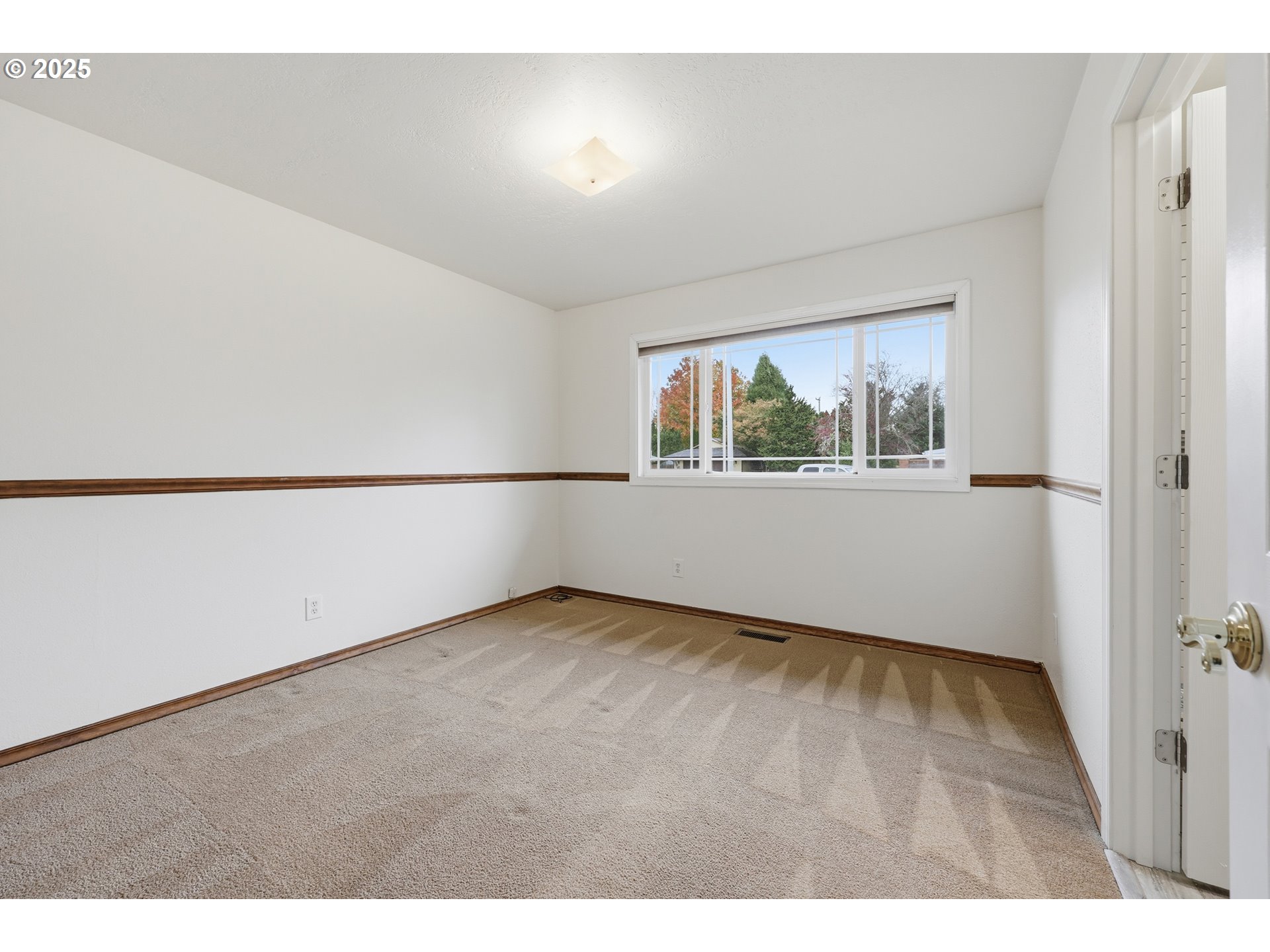 1920 Northeast View Court Gresham, OR 97030 - Photo 20 of 48 a view of an empty room with wooden floor and a window