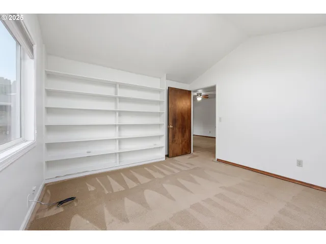 a view of an empty room with empty shelves