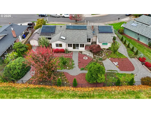 an aerial view of multiple houses with a yard