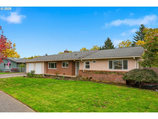 a view of a yard in front of a house with garage