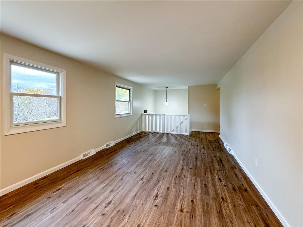 152 William Circle McKees Rocks, PA 15136 - Photo 6 of 16 a view of an empty room with wooden floor and a window