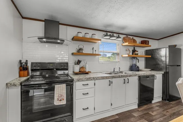 a kitchen with stainless steel appliances granite countertop a stove and a refrigerator