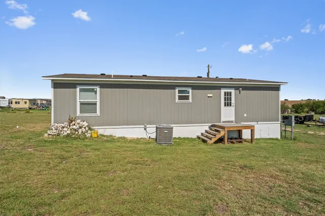a view of a house with backyard porch and sitting area