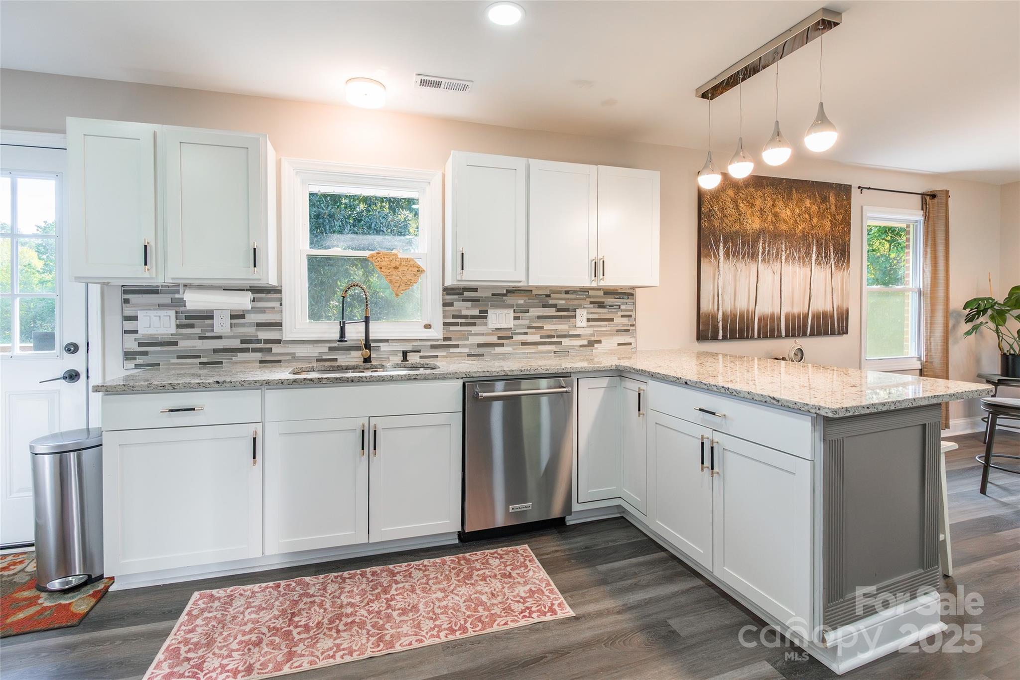 749 Meadowbrook Road Chester, SC 29706 - Photo 11 of 33 a kitchen with stainless steel appliances granite countertop a sink stove and cabinets