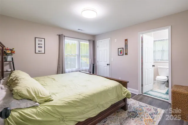 a bedroom with a bed and a view of bathroom