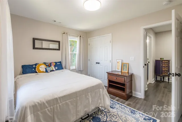 a bedroom with a bed and a dresser