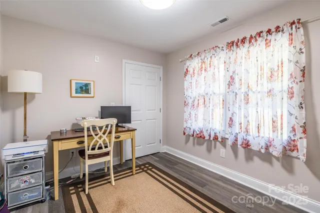 a dining room with furniture and a window