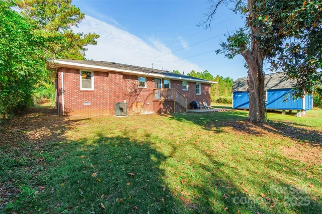 a front view of house with yard and trees