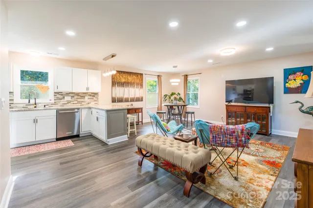 a living room with furniture and kitchen view