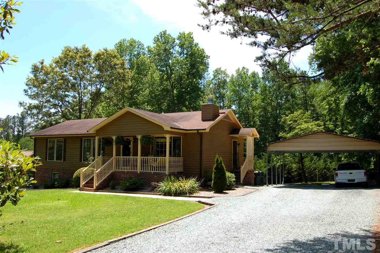 6109 Russell Road Durham, NC 27712 - Photo 1 of 25 a front view of a house with a yard and trees
