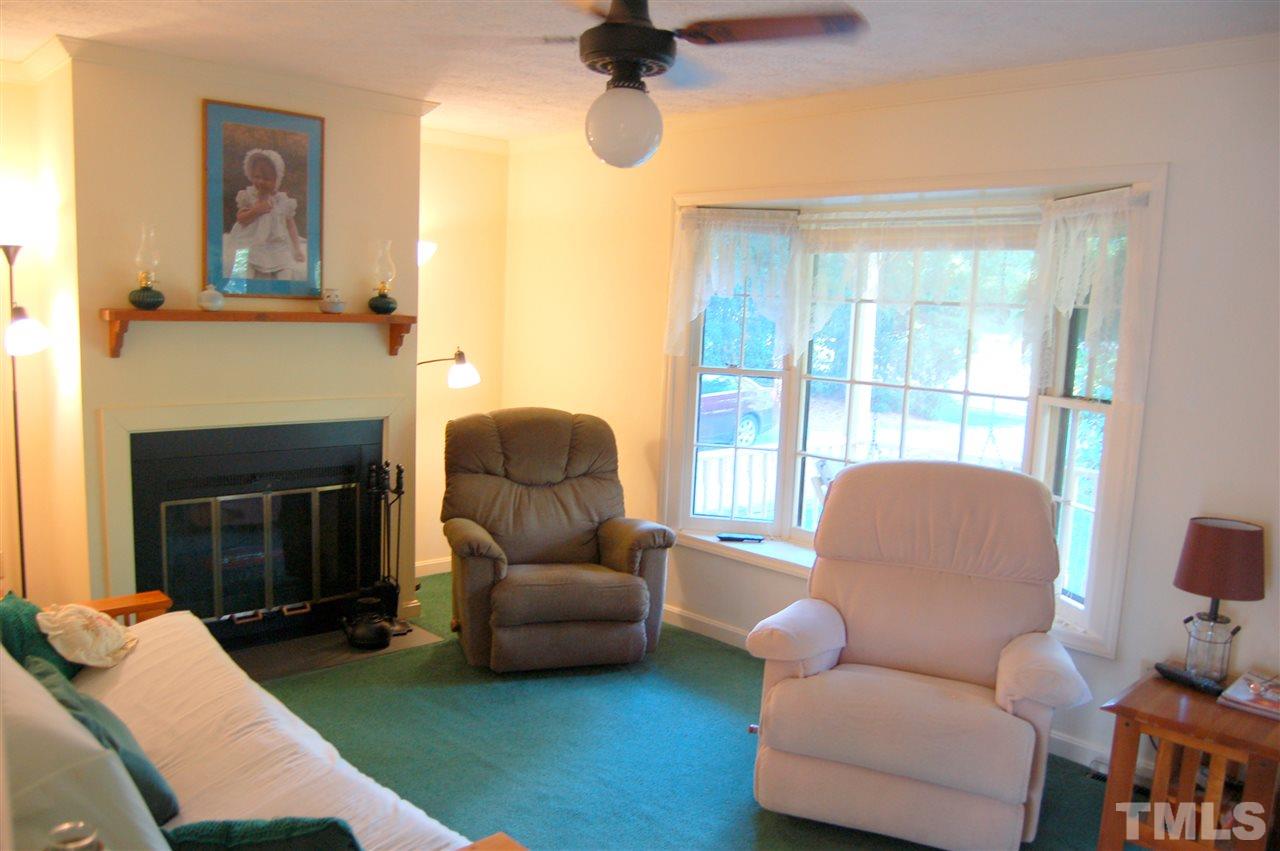 6109 Russell Road Durham, NC 27712 - Photo 2 of 25 a living room with furniture and a fireplace