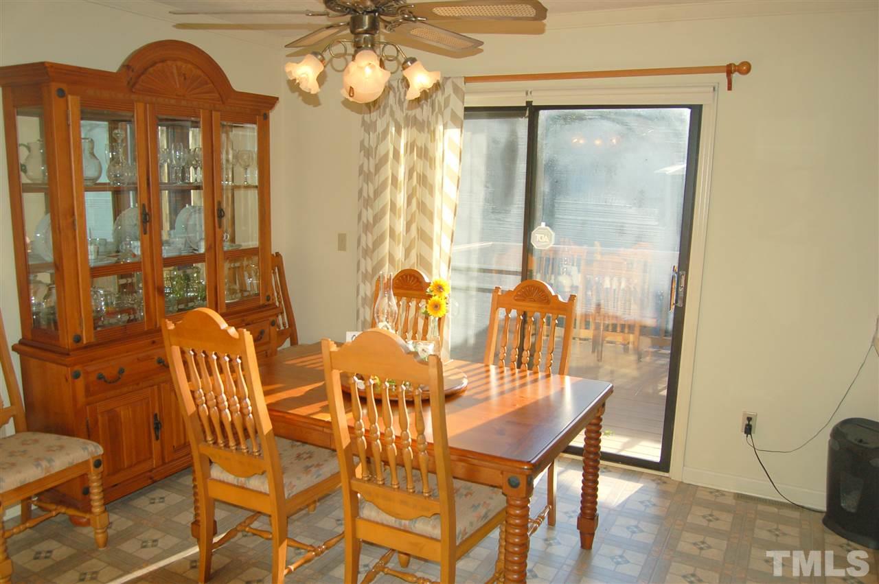 6109 Russell Road Durham, NC 27712 - Photo 12 of 25 a view of a dining room with furniture and a chandelier