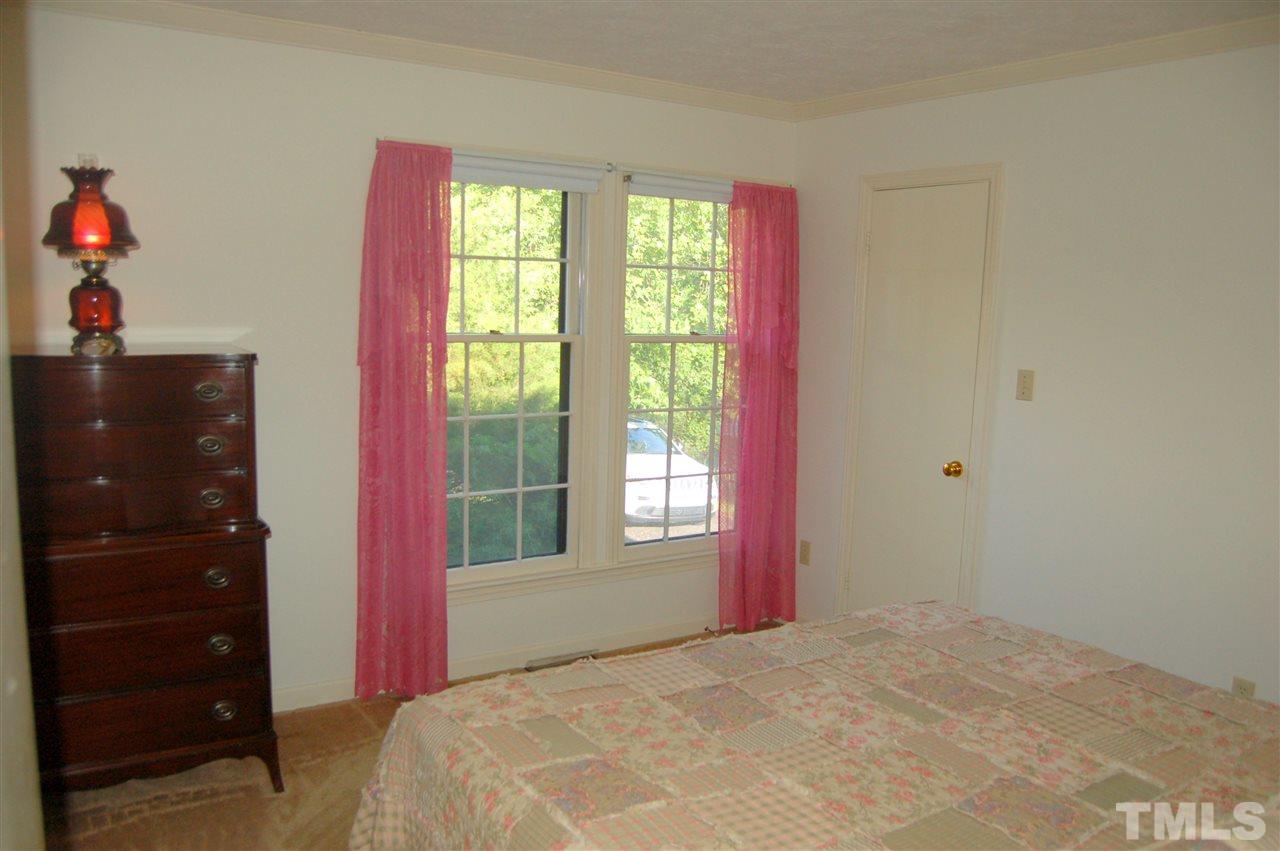 6109 Russell Road Durham, NC 27712 - Photo 15 of 25 a bedroom with a bed and a window