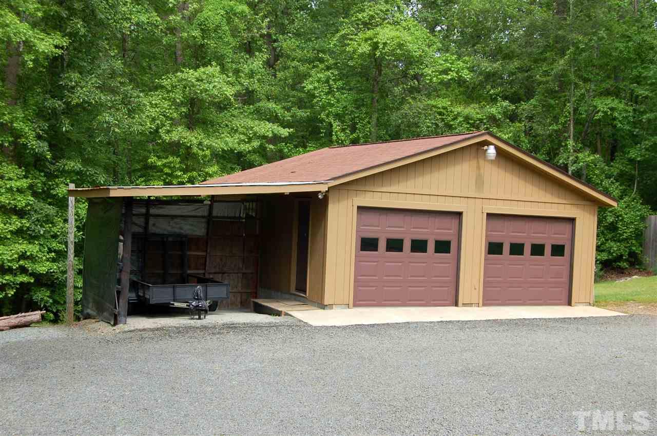 6109 Russell Road Durham, NC 27712 - Photo 19 of 25 a front view of a house with a yard and garage