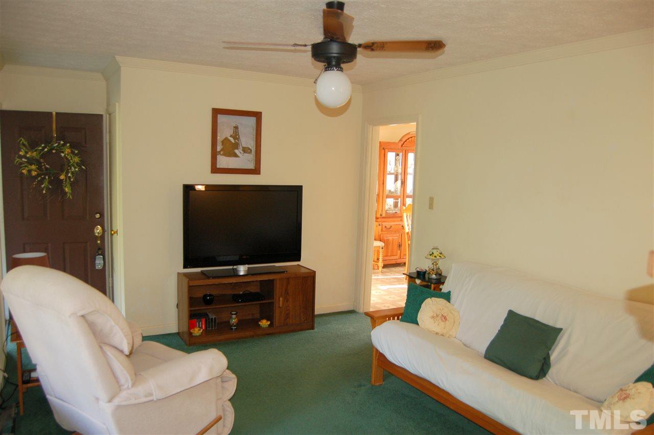 6109 Russell Road Durham, NC 27712 - Photo 4 of 25 a living room with furniture and a flat screen tv