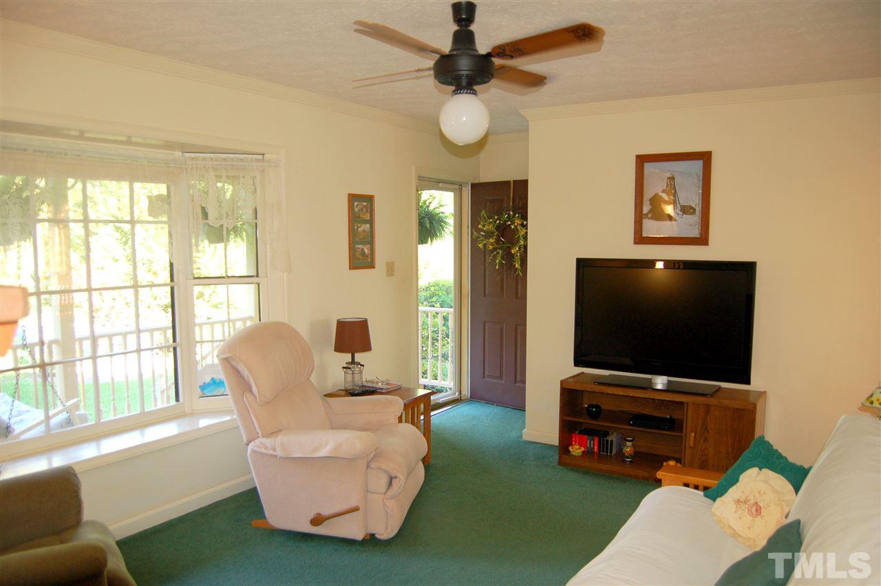 6109 Russell Road Durham, NC 27712 - Photo 6 of 25 a living room with furniture and a flat screen tv