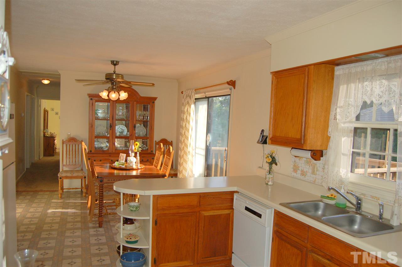 6109 Russell Road Durham, NC 27712 - Photo 9 of 25 a kitchen with a sink cabinets and window