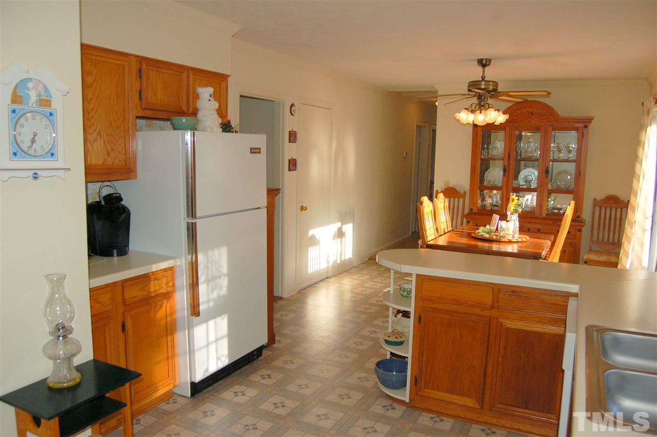 6109 Russell Road Durham, NC 27712 - Photo 10 of 25 a kitchen with stainless steel appliances a refrigerator and a stove top oven