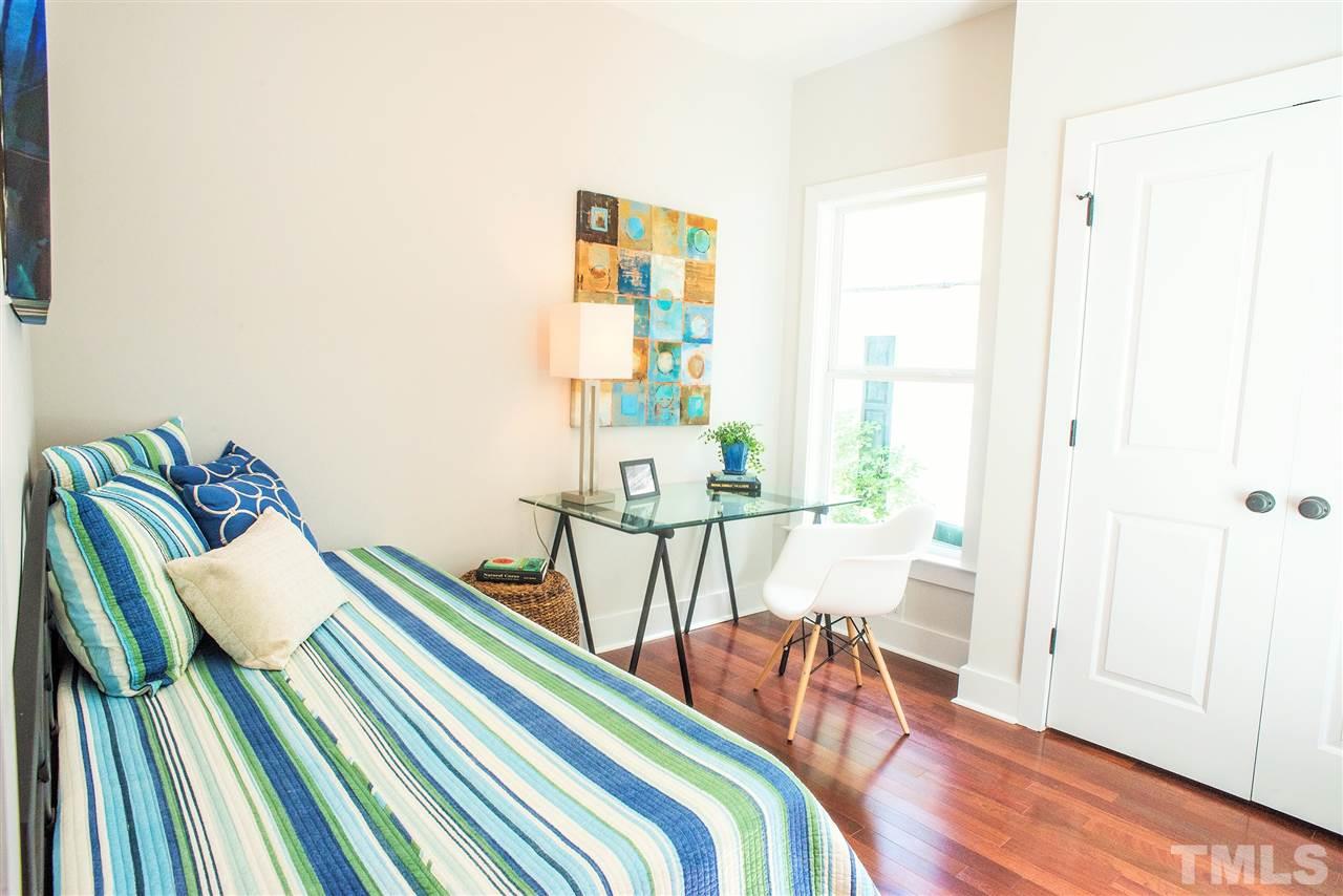 508 Worth Street Raleigh, NC 27601 - Photo 14 of 16 a bedroom with a bed and a table