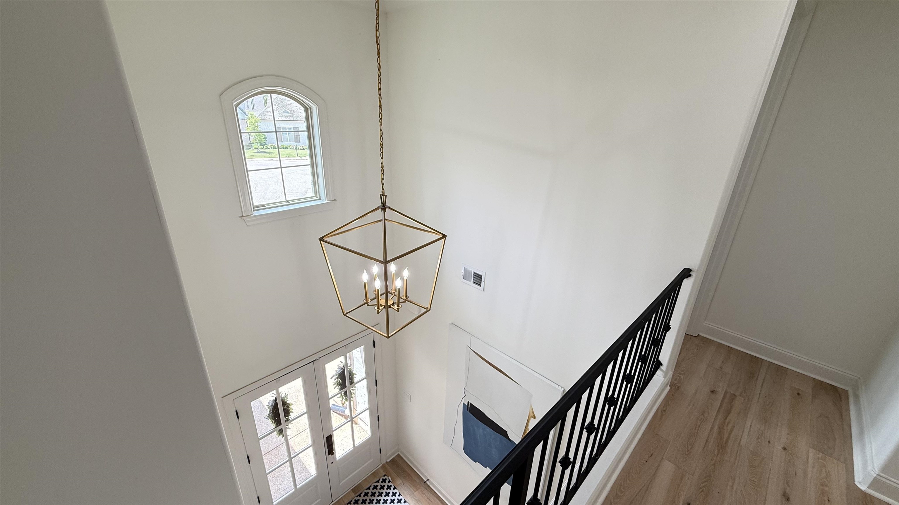 1746 Chadwick Farms Loop North Collierville, TN 38017 - Photo 25 of 35 Stairs featuring a chandelier, wood finished floors, and a towering ceiling