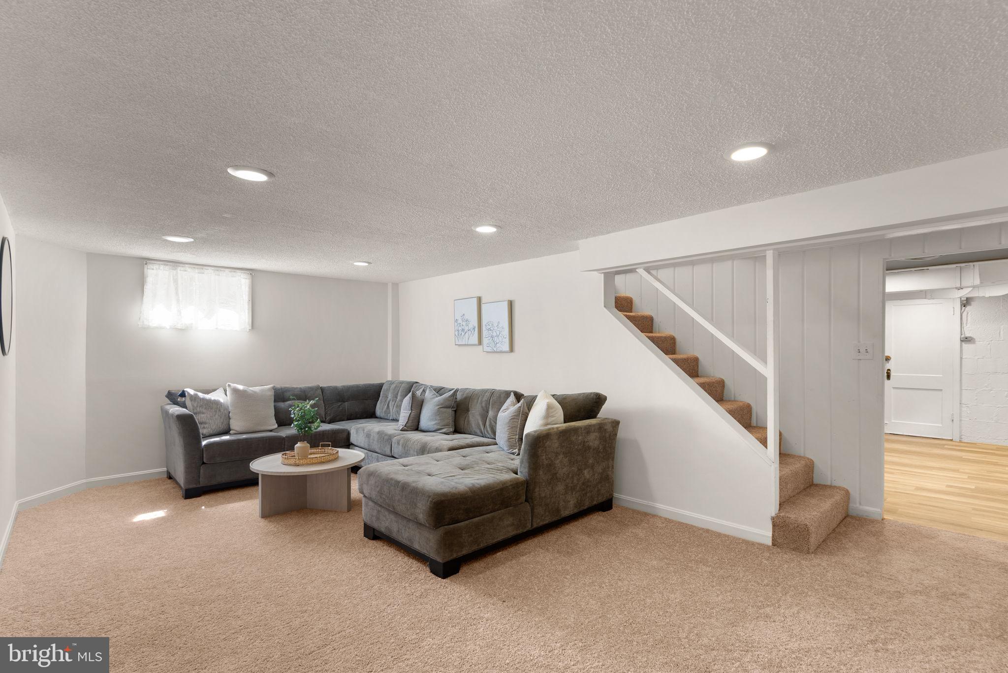 9601 Sutherland Road Silver Spring, MD 20901 - Photo 32 of 48 a living room with furniture and stairs