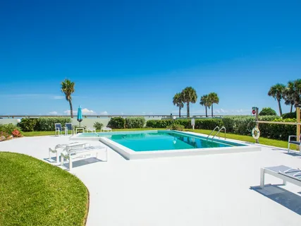 a view of a swimming pool with an outdoor space and seating area