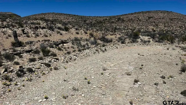 a view of a mountain with a mountain in the background