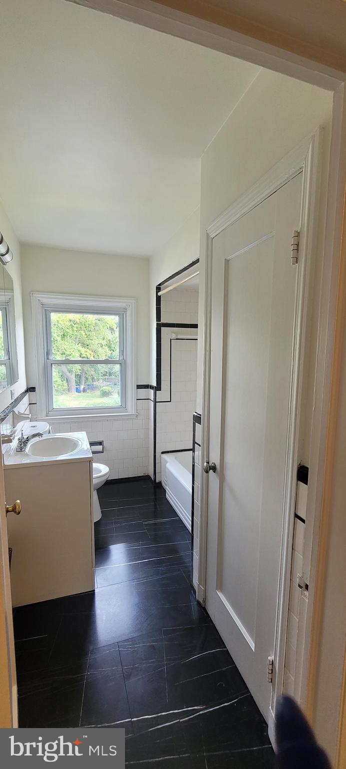 1565 Stonewood Road Baltimore, MD 21239 - Photo 23 of 43 Full Bath Tub & Linen Closet