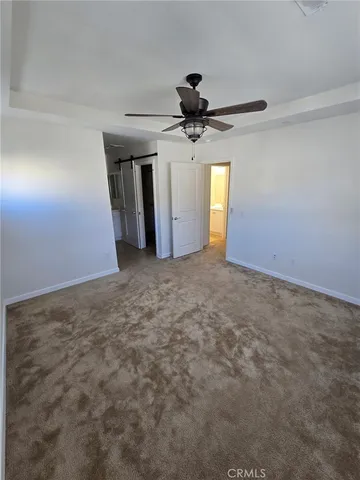 a view of a livingroom with a ceiling fan and window