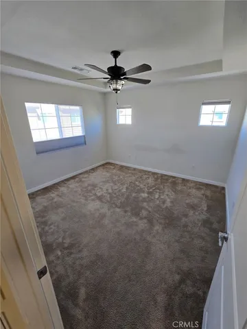 a view of an empty room and a window