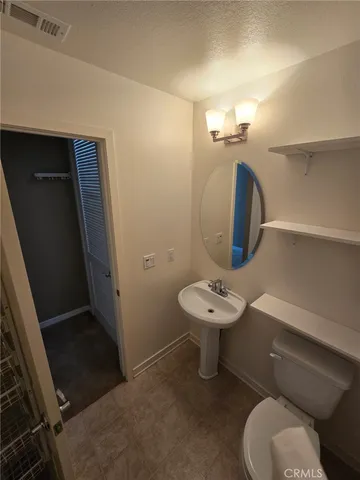 a bathroom with a sink mirror and toilet