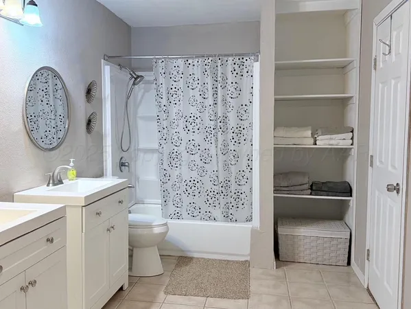 a bathroom with a sink a toilet a mirror and vanity