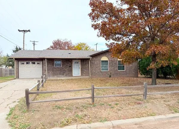 a view of a house with a large tree